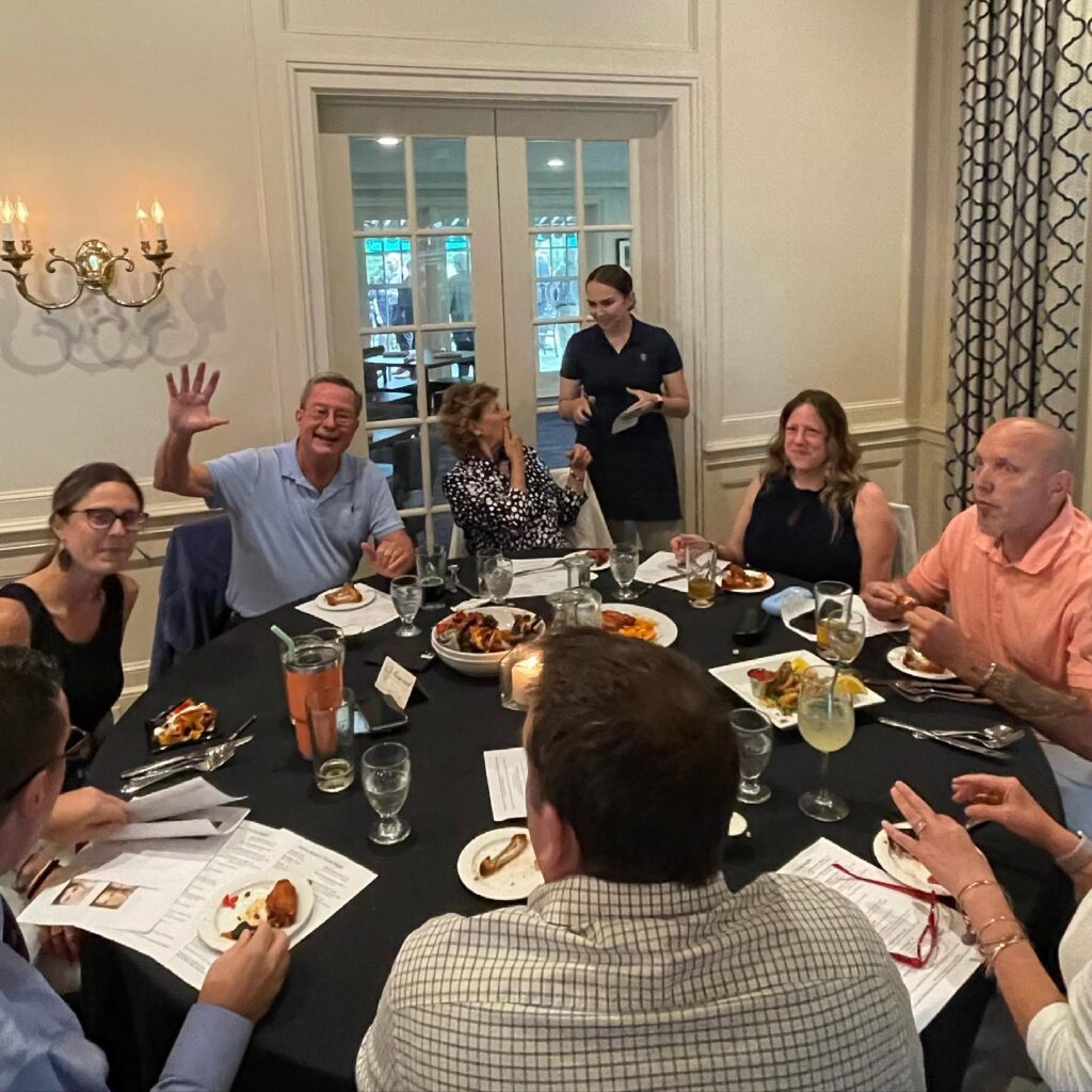 Guests celebrating around a dinner table at Shuttle Meadow