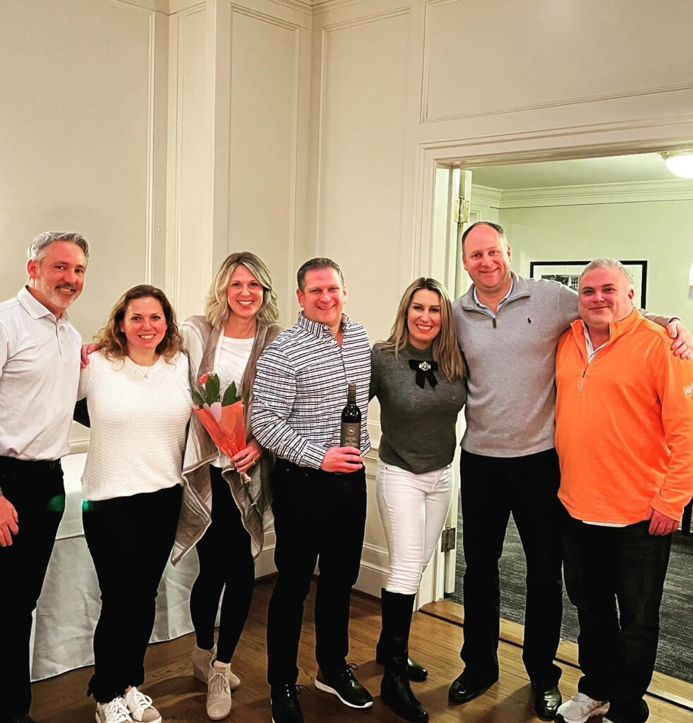 Colleagues gathered for a company event at Shuttle Meadow Country Club