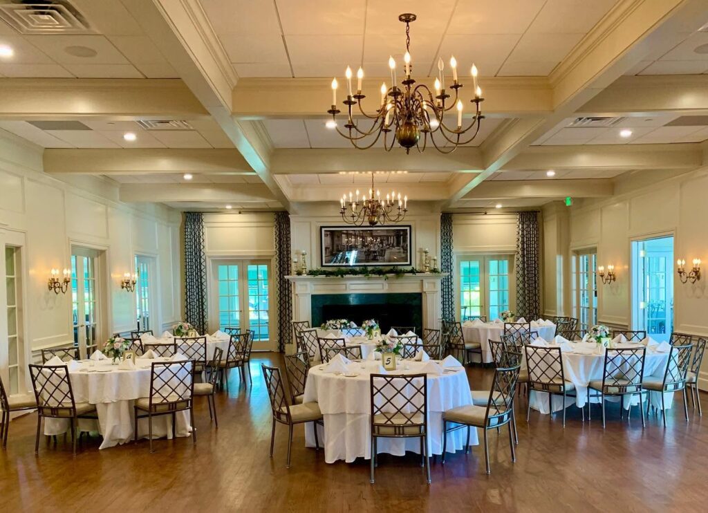 Chandelier-lit event room with a fireplace at Shuttle Meadow