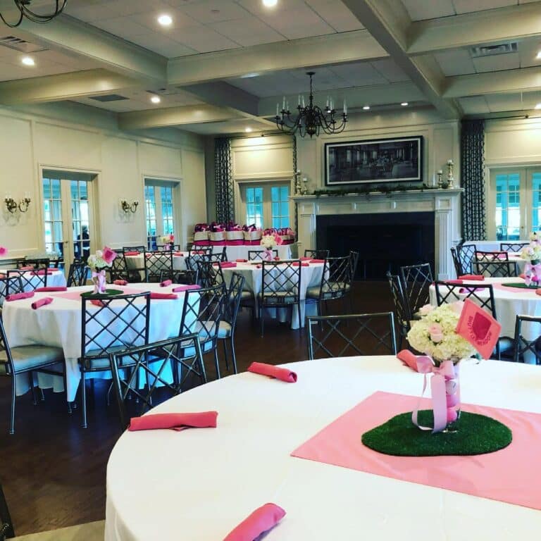 Private Events room at Shuttle Meadow Country Club Showng tables set with white and pink