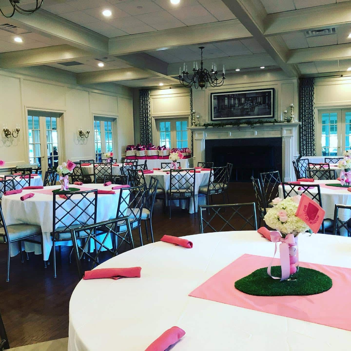 Private Events room at Shuttle Meadow Country Club Showng tables set with white and pink